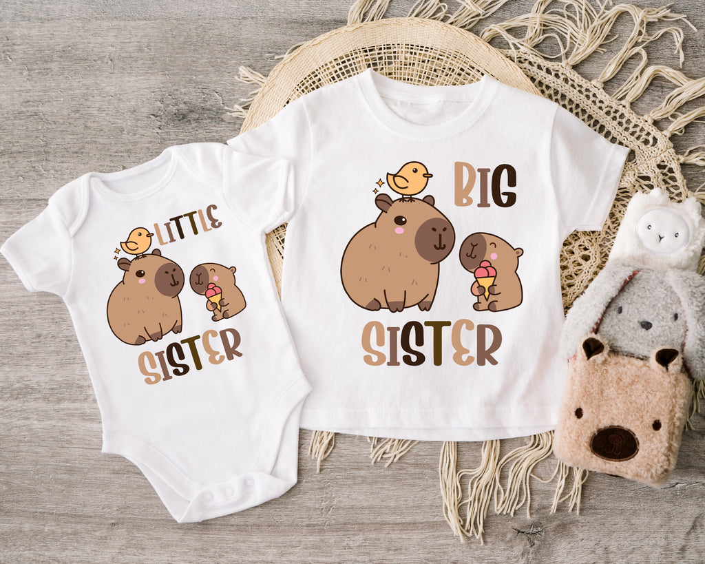 Get trendy with Capybara Big Sister Little Sister T-Shirt Baby Grow Set -  available at DizzyKitten. Grab yours for £9.45 today!