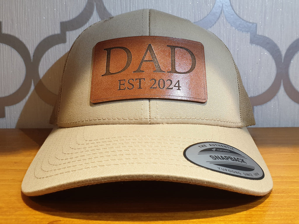 Get trendy with Dad Est 2024 Real Leather Patch Trucker Hat - Hat available at DizzyKitten. Grab yours for £26.49 today!